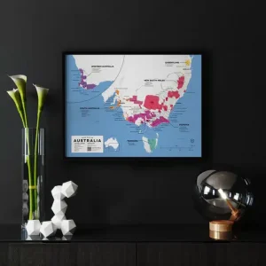 Framed wine region map of Australia on a black wall above a modern console table with decorative items.