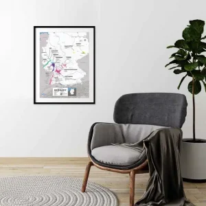 Framed map of Germany's wine regions hanging above a cosy chair in a minimalist room.