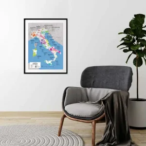 Framed wine region map of Italy on a white wall above a grey armchair in a minimalist room.