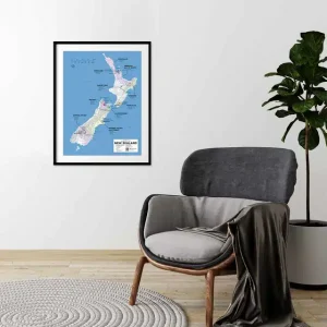 Framed New Zealand wine map above a grey armchair in a minimalist room.