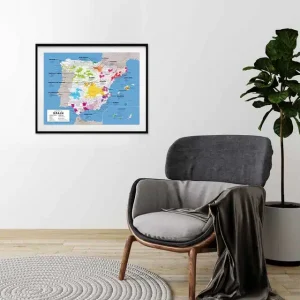 A framed map of Spain's wine regions hangs above a cosy grey armchair in a minimalist room.