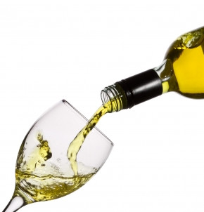 White wine being poured into a glass.