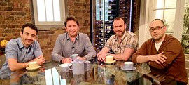 Four hosts from the TV show Saturday Kitchen Live sitting at a table, each smiling and looking towards the camera.