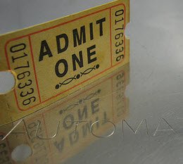 Admit one ticket with reflection on a metallic surface.