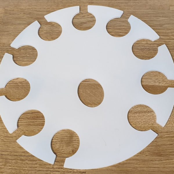 Round white tray with multiple circular cut outs designed to hold glasses.