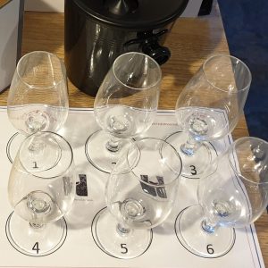 Empty wine glasses arranged on a numbered mat for a wine tasting session.