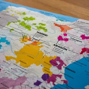 A close-up of a colourful wine region map of Madrid and Aragón, Spain, highlighting different wine-producing areas and varieties.