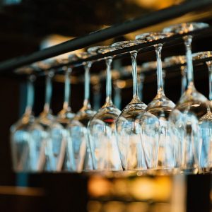 Several rows of hanging wine glasses.