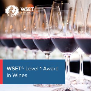 A row of glasses of wine in the background with a blue title box in the bottom left corner saying "WSET Level 1 Award in Wines".