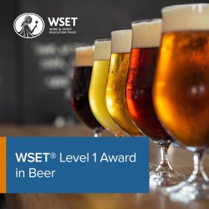 A row of pint of beer in the background with a blue title box in the bottom left corner saying "WSET Level 1 Award in Beer".