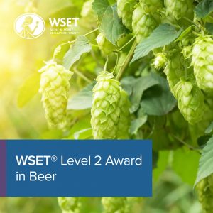 A fruit bush in the background with a blue title box in the bottom left corner saying "WSET Level 2 Award in Beer".