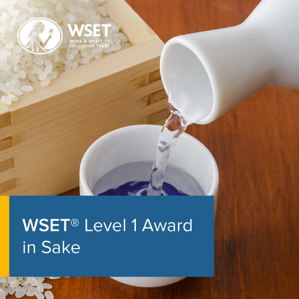 Someone pouring a cup of Sake this o wooden box of rice in the background with a blue title box in the bottom left corner saying "WSET Level 1 Award in Sake".